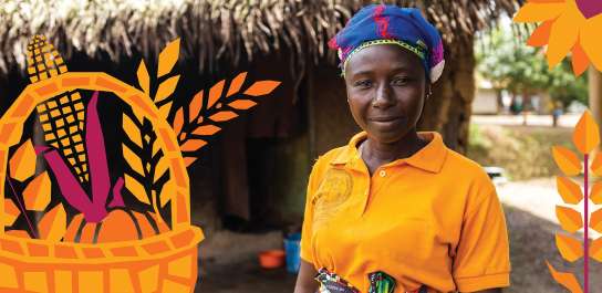A woman in an orange shirt and blue headscarf stands outside a thatched building, smiling slightly. Stylised harvest-themed illustrations of leaves and a basket of crops overlay the image.