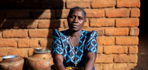 A portrait of a Malawian woman with a neutral facial expression